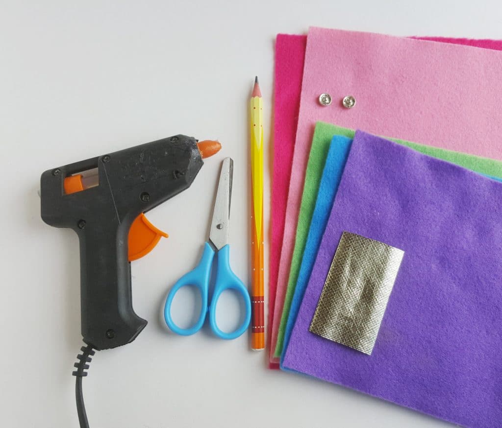 unicorn pencil case supplies including a glue gun and fabric