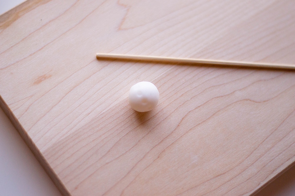 white fondant rolled into ball with skewer