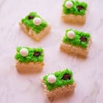 golf rice krispies with green icing, white golf ball and hole with cookie crumbs