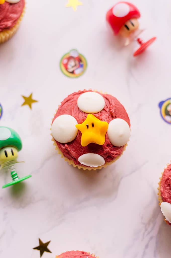close up of mario cupcakes with white chocolate disc and yellow star