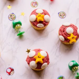 super mario cupcakes on a marble surface and nintendo props