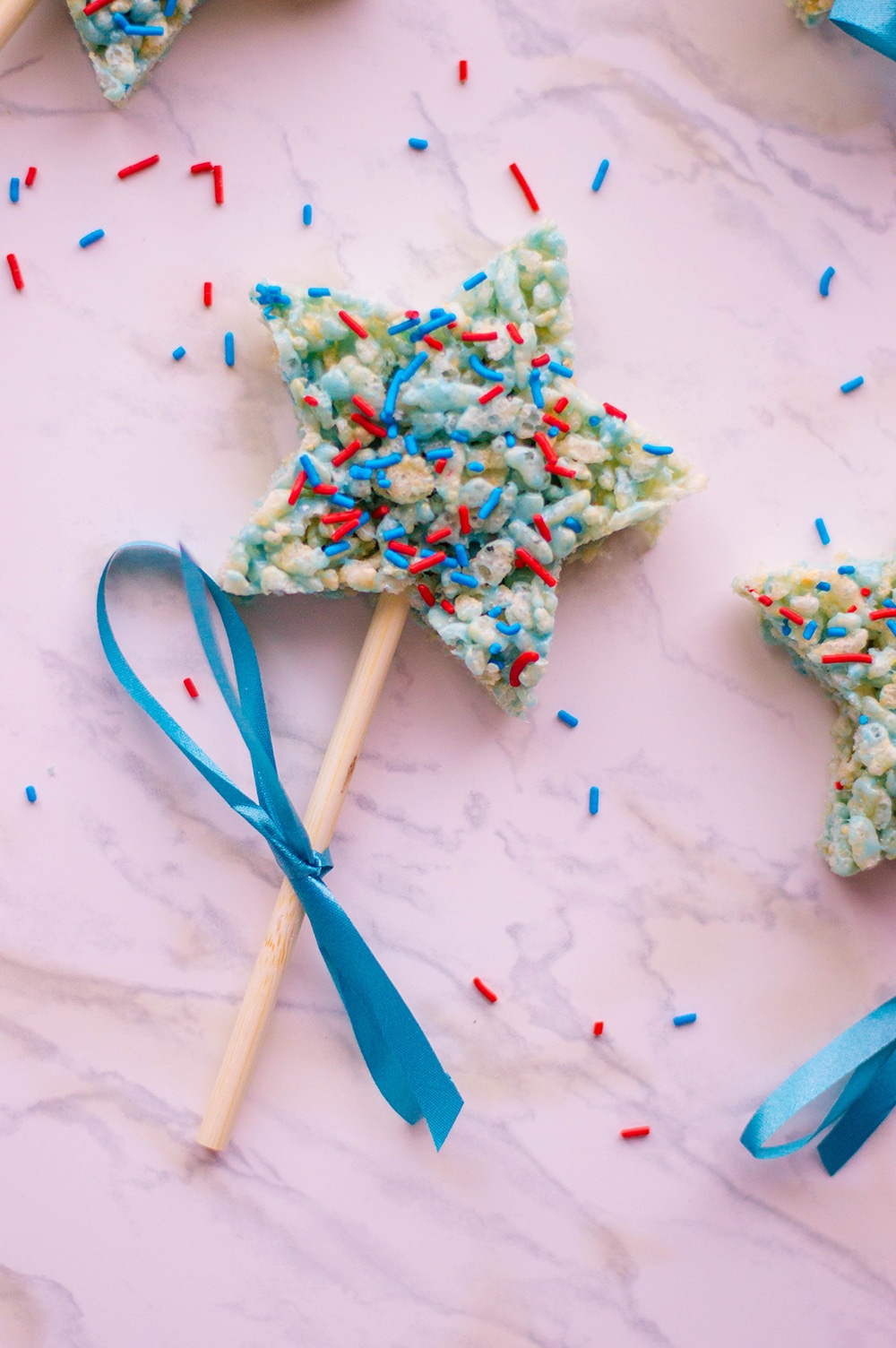 patriotic rice krispies treats on a stick with blue ribbon