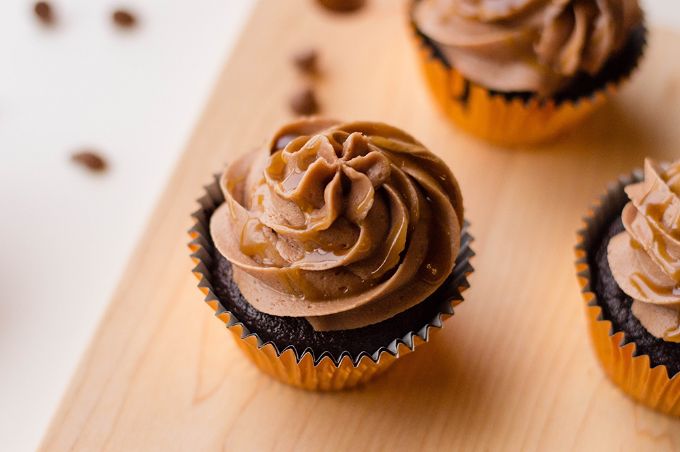closeup of caramel cupcakes on wooden serving tray