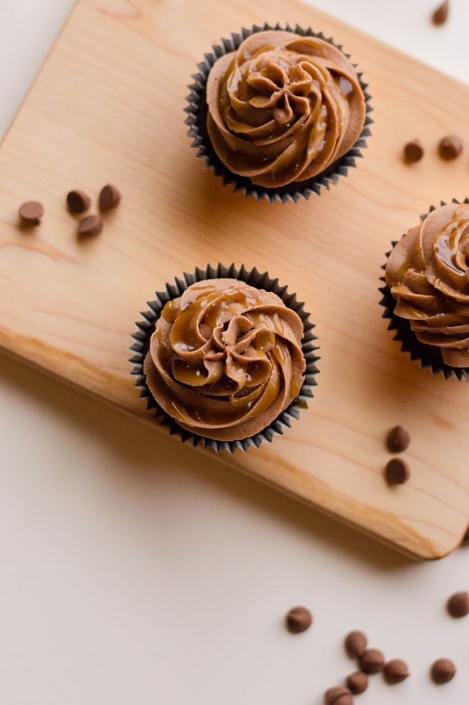 overhead shot of caramel cupcakes with chocolate chips scattered arond