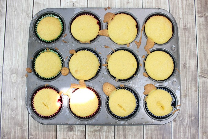 ice cream cone cupcakes fully baked in a muffin tin on a countertop