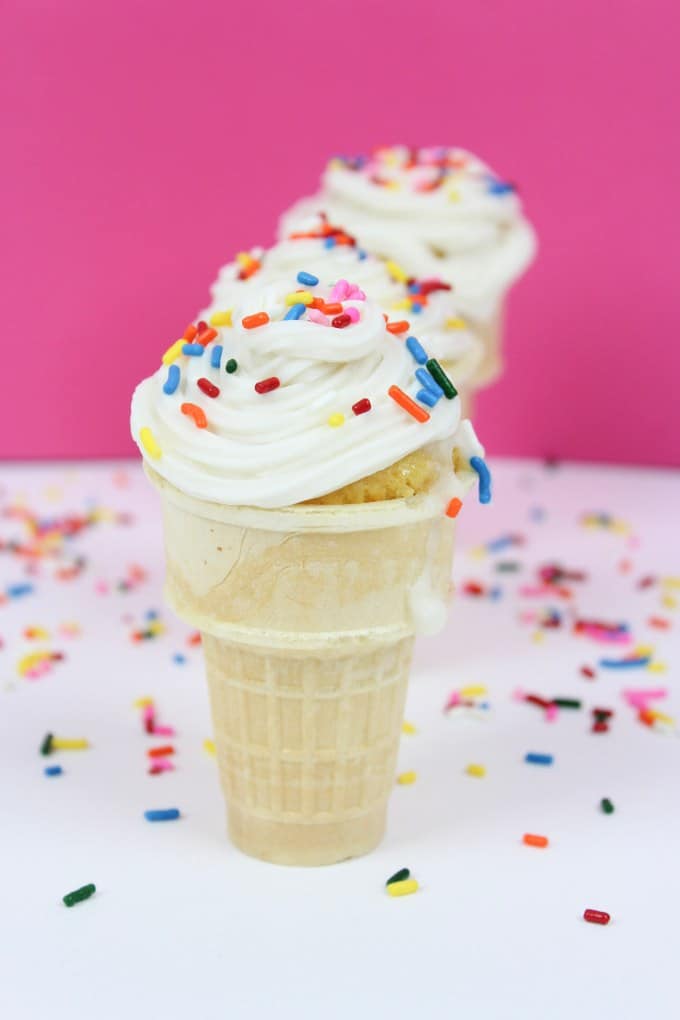 how to make ice cream cone cupcakes with sprinkles on top in front of pink background