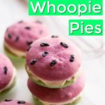 watermelon whoopie pies with black icing seeds on marble backdrop