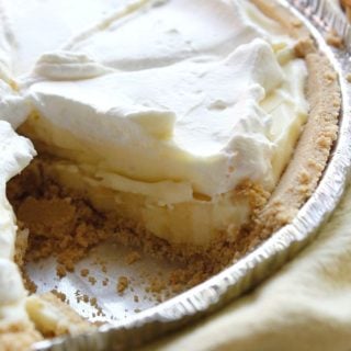 closeup of no bake banana cream pie with one slice missing