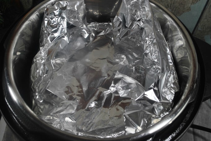 Add the mixture to a round, oven-safe baking dish that will fit inside of your pressure cooking pot. Cover dish with foil.