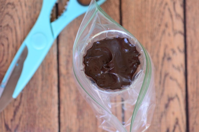 Melt milk chocolate and place it in a ziplock bag. Snip the corner to make it into a piping bag and draw Winnie The Pooh’s face.