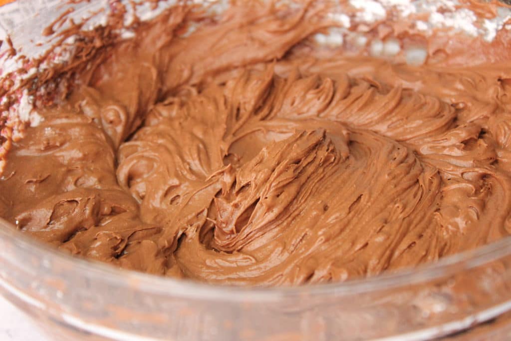 upclose shot of chocolate fudge icing in bowl