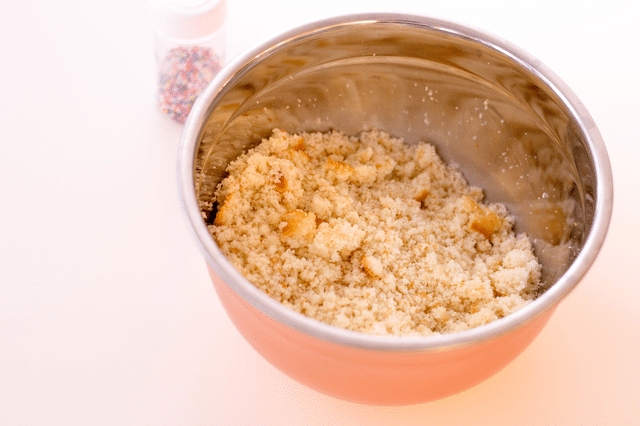 cake crumbles in a mixing bowl, sprinkles