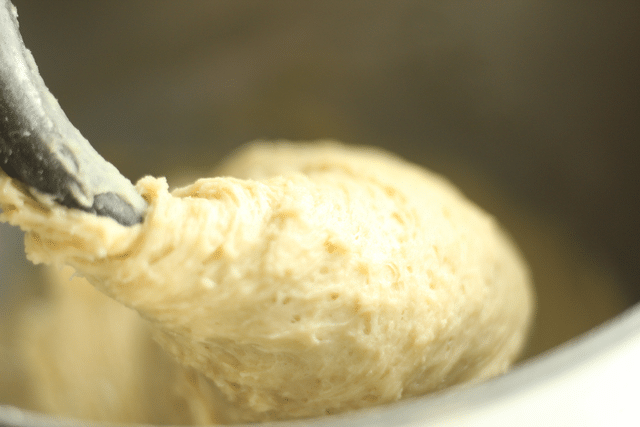 homemade roll dough on mixing hook