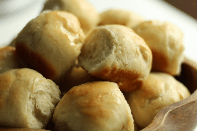 homemade rolls in wooden bowl