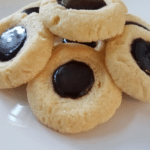 thumbprint cookies with chocolate icing on white plate