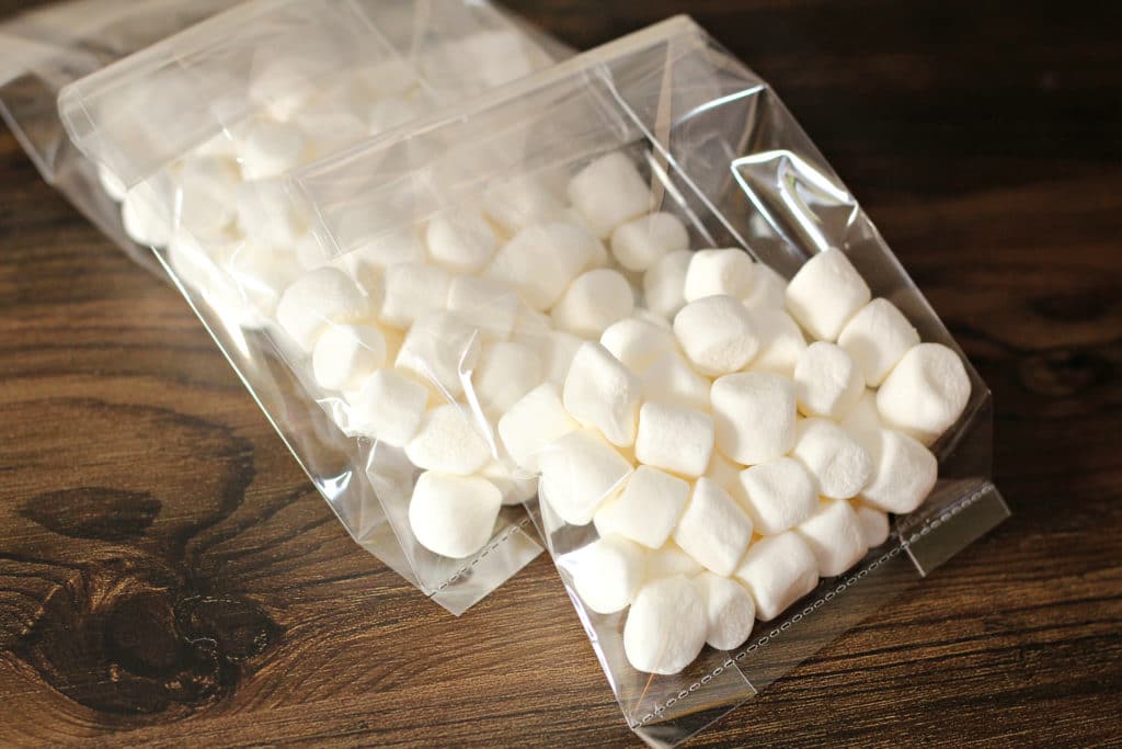 bags of marshmallows on table to snowman poop