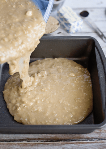 pouring wet cake mix into baking pan
