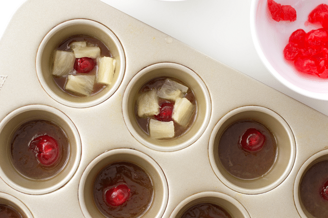 melted butter and brown sugar, cherries, pineapples in muffin tin