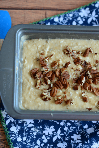 cream cheese banana bread mixture with pecans in baking dish