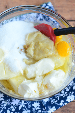 sugar, butter, eggs, mashed bananas in mixing bowl with spoon