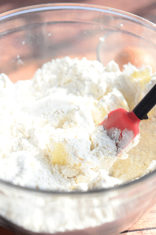 flour, butter, sugar in a mixing bowl with spoon