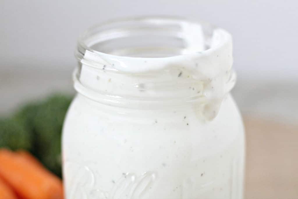 close up picture of ranch dressing on a mason jar top