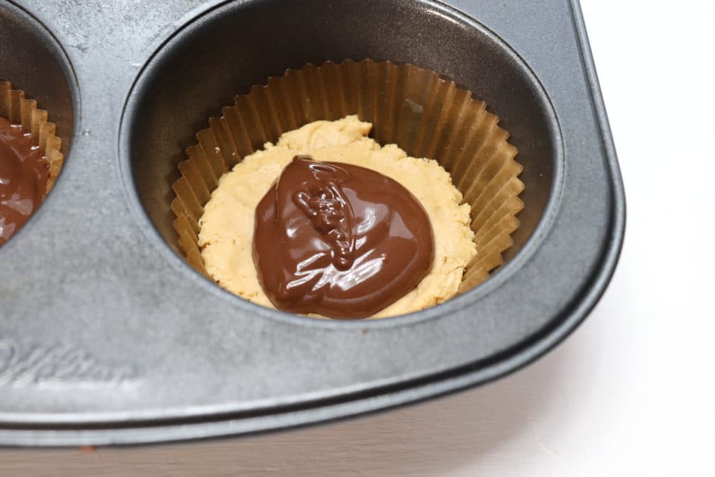 Add chocolate to the top of the peanut butter cups