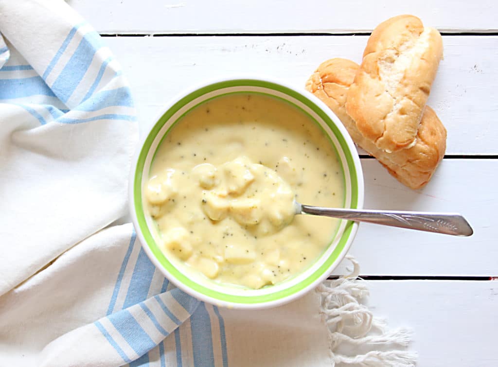 bowl of broccoli cheddar soup and a piece of bread