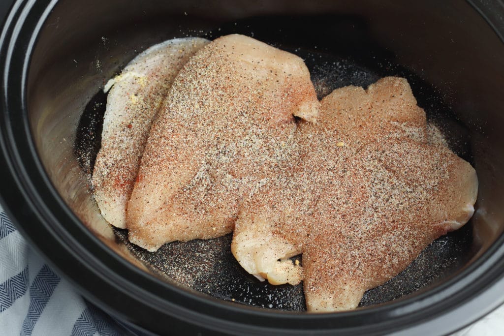 chicken with seasoning in a slow cooker