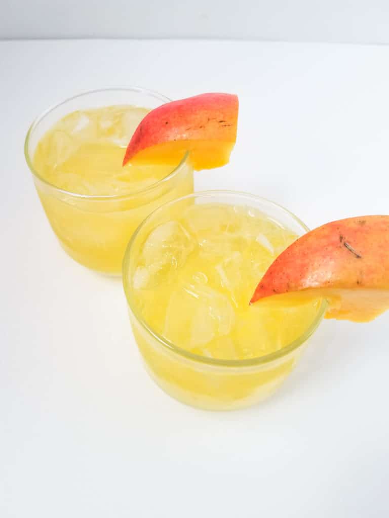 glasses of mango vodka cocktail with mango