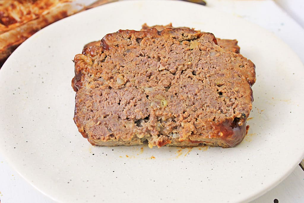 slice of classic meatloaf on a white plate