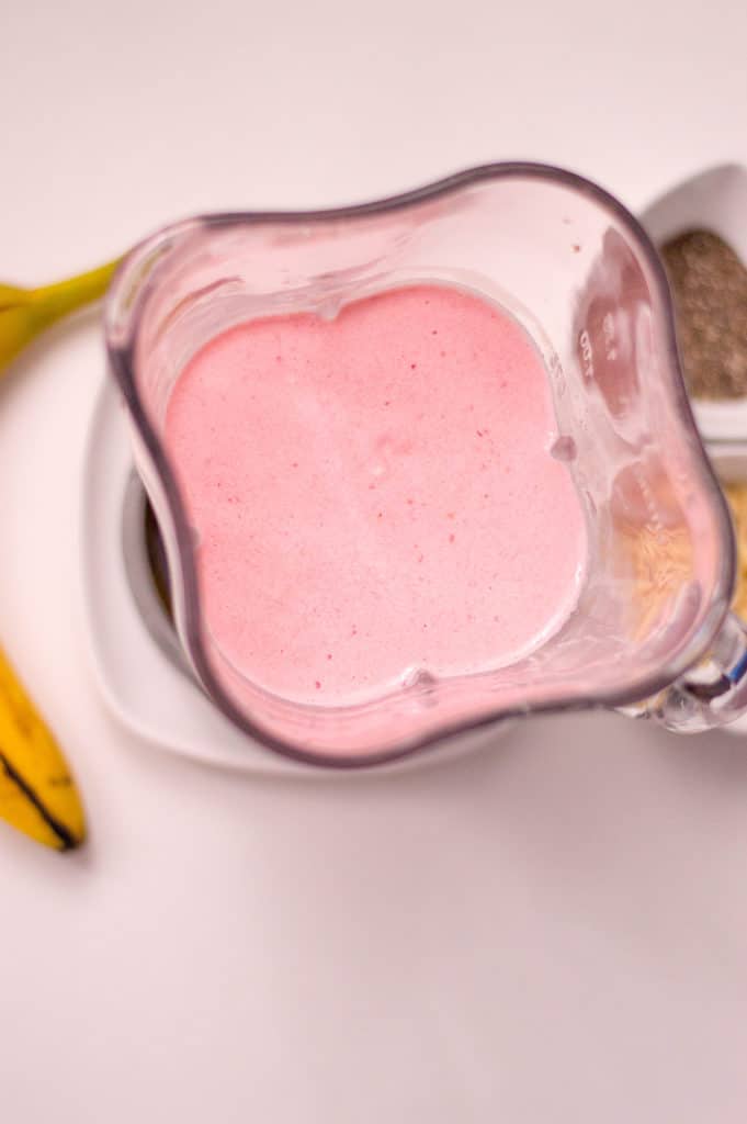blender with strawberry smoothie