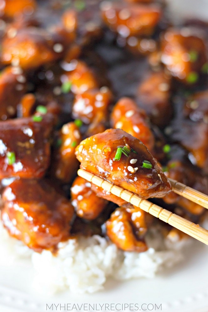 chopstick holding bourbon chicken piece