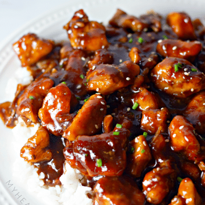 close up bourbon chicken on a plate with rice