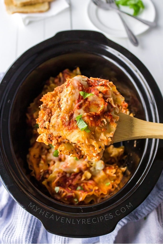 spoon scooping lasagna out of slow cooker