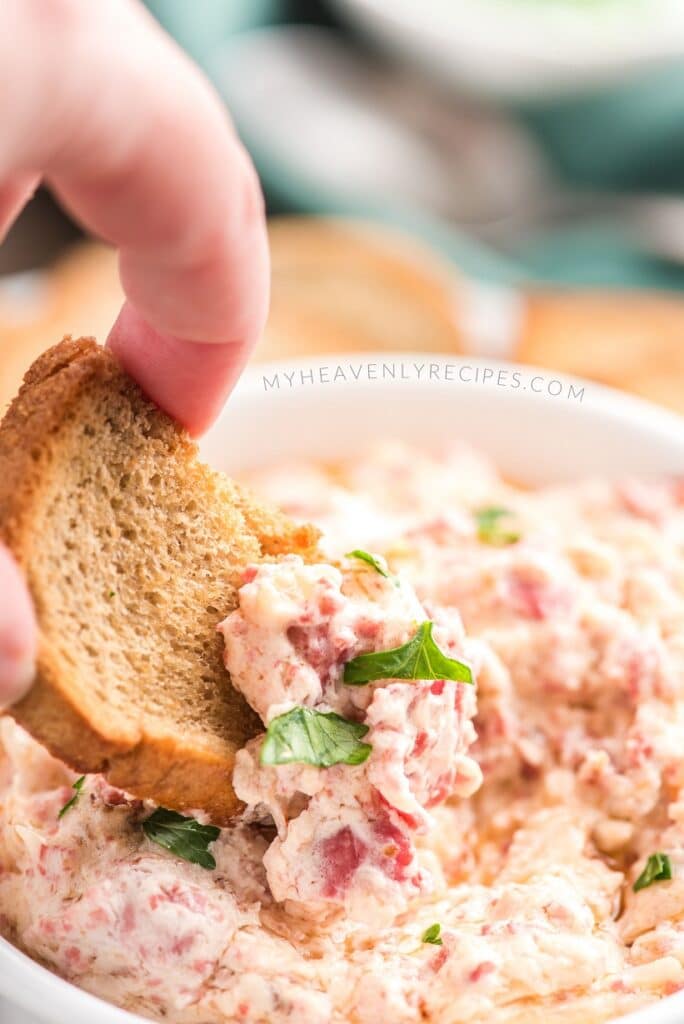 dipping cracker in reuben dip